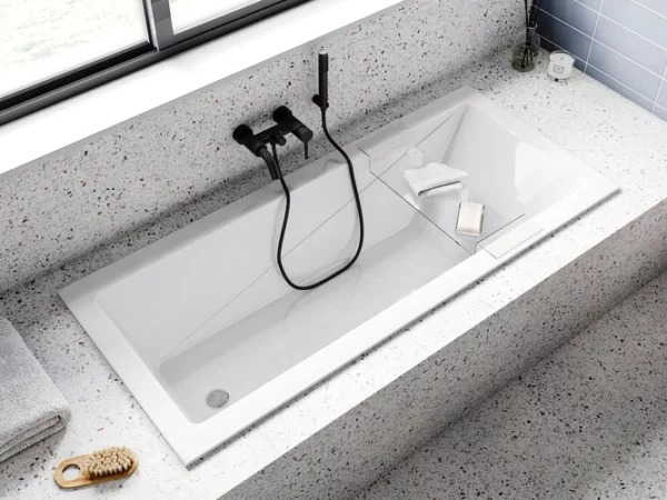 Wanna Prostokątna Besco Modern Slim Prostokątna wanna akrylowa Besco Modern Slim w blacie z lastryko terrazzo z czarną armaturą podtynkową