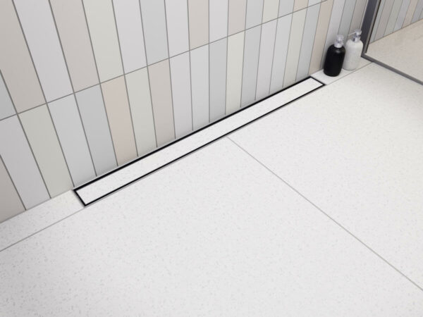Nowoczesna kabina prysznicowa walk-in z odpływem przyściennym Vogi Premium SLX Duo zabudowanym jasnymi płytkami ceramicznymi.