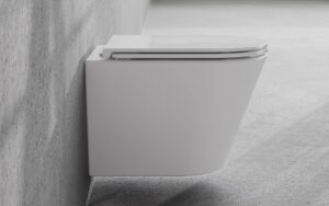 Miska WC Besco Laax White Biała podwieszana miska WC Besco Laax zamontowana na szarej betonowej ścianie nowoczesnej łazienki.